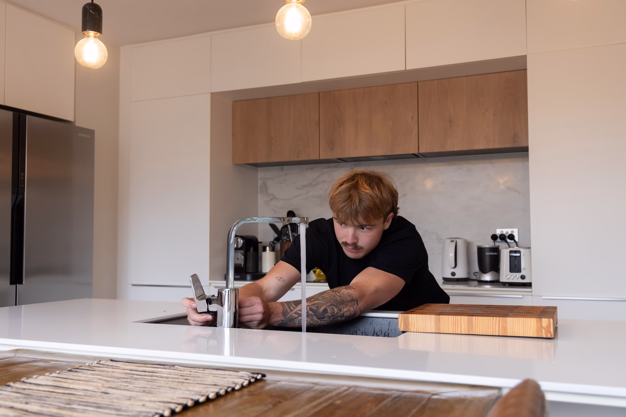 FOLEYS worker installing kitchen tap