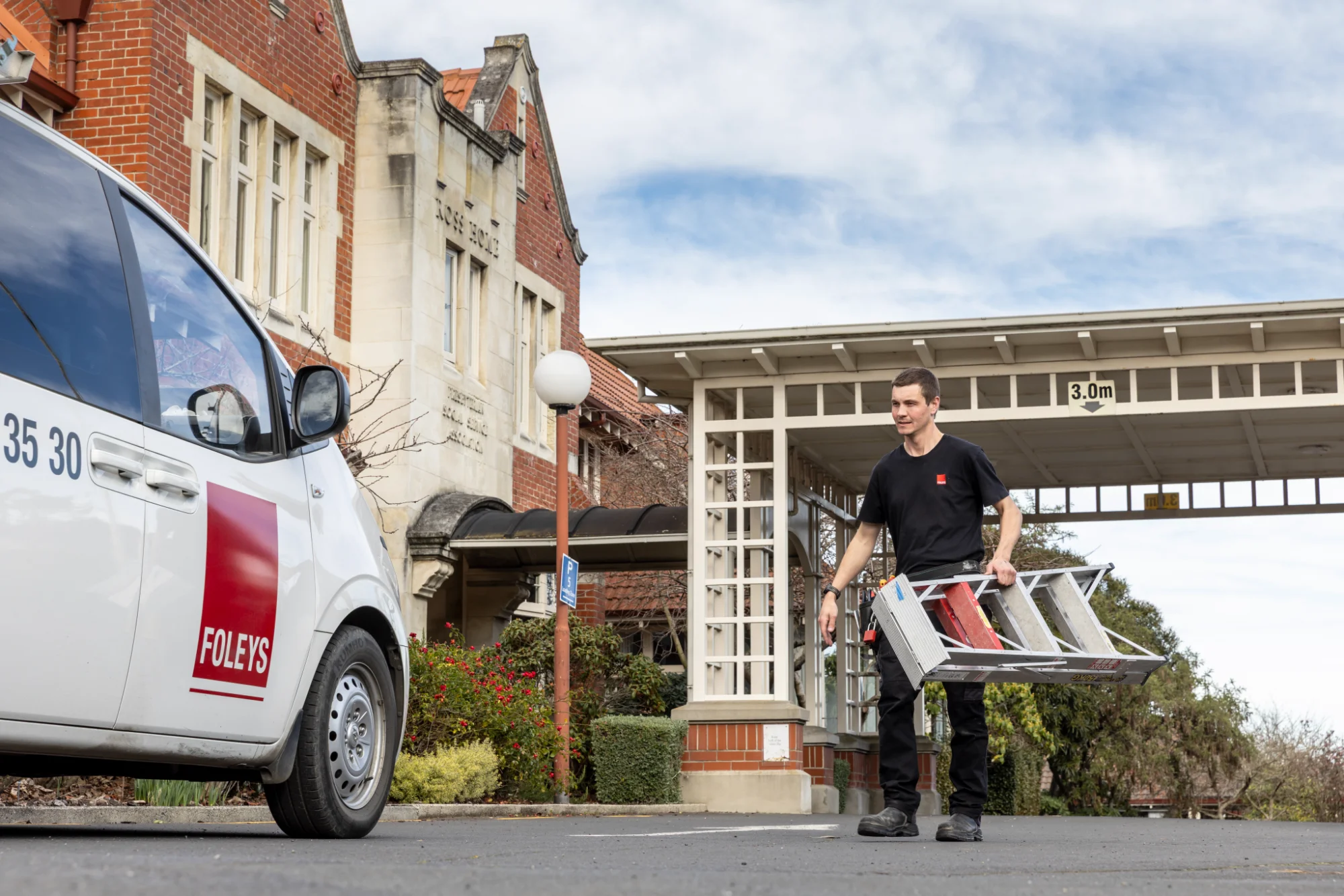Foleys worker carring a ladder to his van at Ross Home, Dunedin